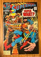Front cover of Superman comic book issue 231 featuring colorful artwork of Superman getting punched by a large golden robot with 'Super What?' text bubble.