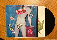 Front cover of the Rolling Stones Undercover vinyl album showing the nude torso with stickers.