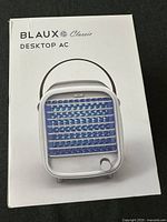 Front view of boxed Blaux Classic Desktop AC showing product image and branding