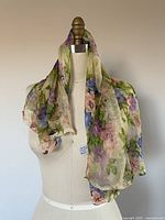 Floral scarf draped on mannequin showing full pattern and texture.