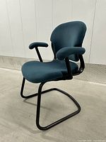 Front-side view showing overall chair shape, upholstery and armrests