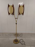 Full front view of lamp showing dual adjustable shades, brass column and round base