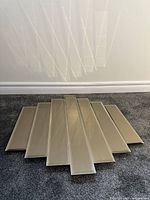 Front view of multi-panel mid-century modern wall mirror showing reflective panels with beveled edges and smoky tint.