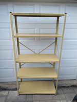 Front view of the metal storage shelving unit showing all five shelves and the full height of the unit.