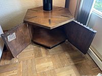 Hexagonal side table with cabinet doors open showing interior storage shelf.