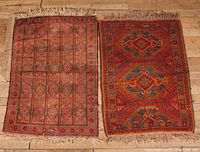 Two vintage prayer rugs laid side by side, full view of both rugs.