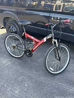 Full side view of the red Honda HR-260FS mountain bike showing frame, tires, seat, and handlebar grips.