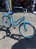 Full view of the Schwinn Delmar blue beach cruiser bicycle showing frame, wheels, handlebars, and rear rack.