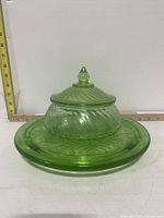 Set of candy dish placed on the uranium glass tray illustrating matching color and style.