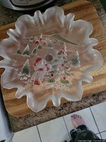 Top view of the frosted glass scalloped bowl showing Christmas trees and a figure in red paint.