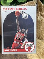 Front of the 1990 NBA Hoops Michael Jordan basketball card showing Jordan dunking in Chicago Bulls uniform, card number 65.