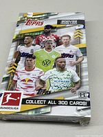 Front view of the sealed 2021/22 Topps Bundesliga soccer trading cards hobby box showing players and title.