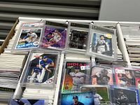 Box interior with stacks of loose cards and several slabbed graded cards on top including an Aaron Sanchez Blue Jays card