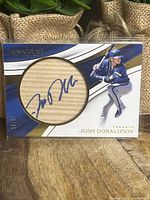 Front view of Josh Donaldson autographed bat card with serial number 10/25.