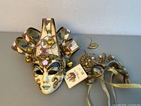 Top-down view of the pair of decorative Venetian style masks on a flat surface.
