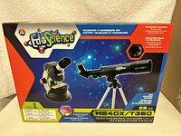 Box front showing EduScience branding and images of the telescope and microscope included in the set
