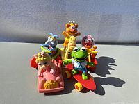 Five vintage McDonalds Muppet Babies toy figures arranged standing, showing front detail.