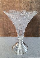 Crystal vase with detailed cut patterns and silver base