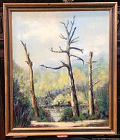 Full view of the oil on board landscape painting showing three bare trees, pond, and surrounding greenery with a wooden frame.