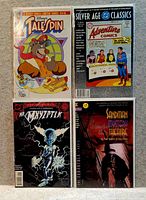 Photo of four collectible comics laid out on a surface: TaleSpin, Silver Age Classics Adventure Comics, Mr. Myxzptlk, and Sandman Mystery Theatre.