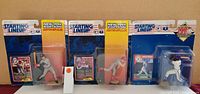 Four Starting Lineup 1994 baseball figurines in original packaging, each accompanied by a collectible card.