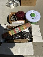 Photo showing incense burner, coffee crock, utensils in box, and salad spinner on the side.