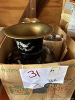 Top view of black Korean vase with brass rim and mother-of-pearl inlay showing bird and floral designs.