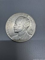 Obverse side of the 1953 Cuban 1 Peso coin showing profile of Jose Marti with inscription '1853 - CENTENARIO DE MARTI - 1953'.