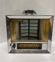 Front view of the vintage Seeburg Wallbox Jukebox showing glass display door with song selection cards and letter/number selection buttons.
