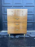 Front view of Mid Century Modern walnut dresser showing four drawers with original hardware and visible wear on surface and edges.