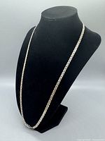 Front view of vintage sterling silver anchor link chain necklace displayed on black bust.