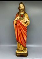 Front view of Vintage Chalkware Sacred Heart of Jesus statue showing full figure with red and gold robes and detailed Sacred Heart symbol on chest.
