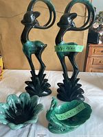 Front view showing the four decorations together on a white cloth background.