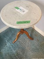 Top view of the round marble tabletop with green tape showing dimensions labeled 15"d x 22 1/2" h.