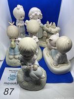 Six Precious Moments porcelain figurines displayed with auction lot number