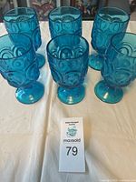 Six blue glass goblets with raised peacock and Moon and Stars pattern