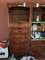 Full front view of tall 2-shelf, 6-drawer dresser with brass handles showing wood grain and condition.