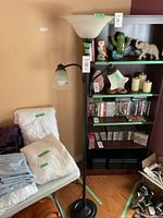 Full view of the black pole lamp with three lights showing the tri-light at top and two single adjustable lights on the sides.