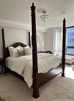 Side angle of assembled bed showing two posts and footboard