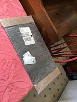 Diamond plate wrapped in plastic with shipping labels and visible size.