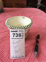 Top view showing inside of Roseville planter with scalloped edge and visible sticker inside.