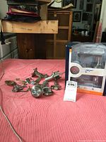 Two Schlage locksets dismantled with parts scattered on red cloth, original packaging box visible