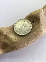 Obverse side of 1943 silver coin showing King George VI's profile with visible tarnish and wear.