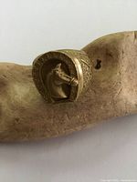 Front angle showing horse head inside horseshoe design on ring.