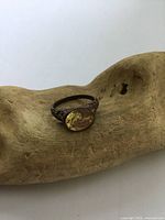 Top view of antique silver filigree ring with oval citrine stone placed on wooden surface