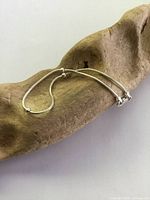 Sterling silver bracelet with silver beads displayed on wood to show design and length.