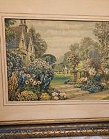 Framed print showing detailed garden with flowers and part of house