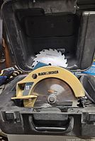 Black & Decker circular saw inside carrying case showing the 11" carbide tooth blade installed.