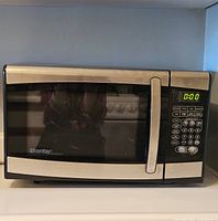 Front view of the Danby Designer microwave oven showing the digital control panel and stainless steel handle.