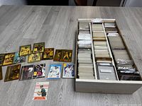 Box with large quantity of miscellaneous NASCAR, baseball, and basketball cards, most sleeved and many loose, some sealed in packages